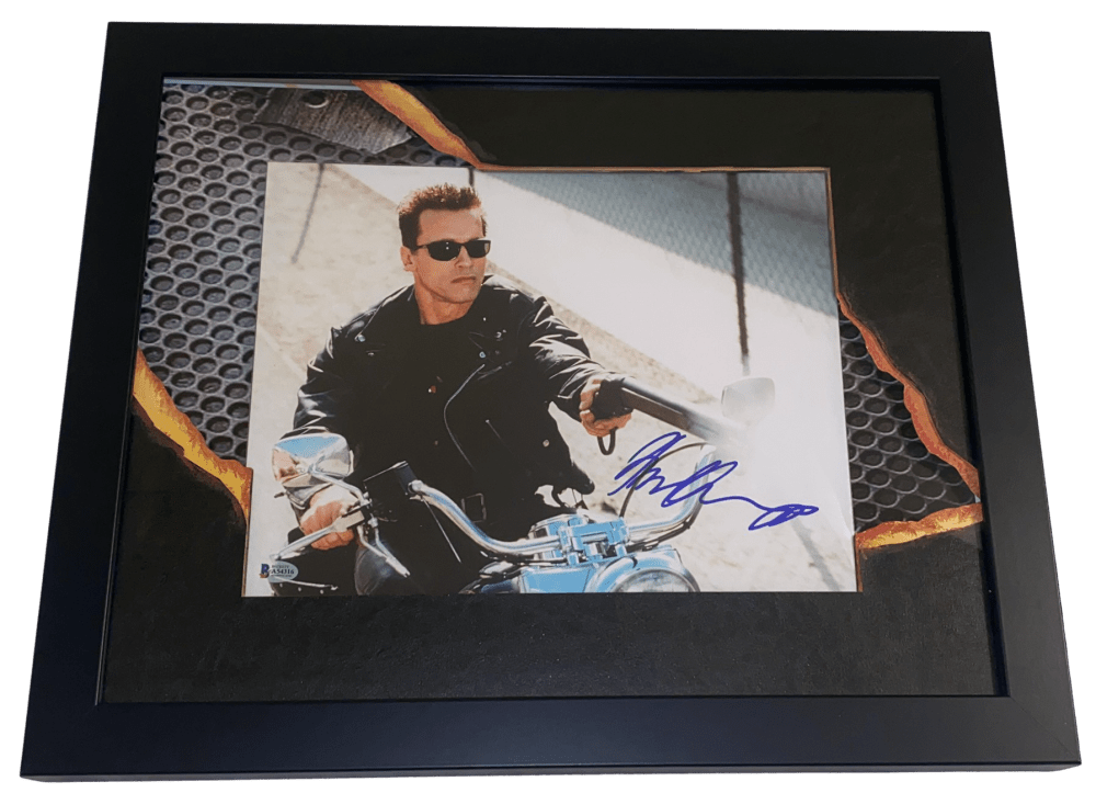 A framed and authenticated Arnold Schwarzenegger signed photograph from The Terminator.